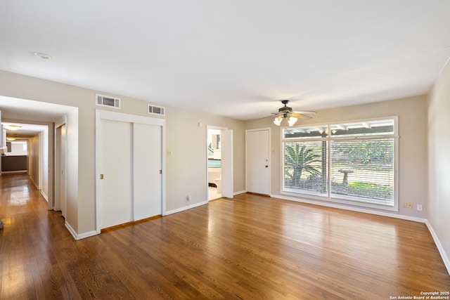 800 Eventide, Terrell Hills, TX 78209 - unfurnished living room featuring visible vents, a ceiling fan, baseboards, and wood finished floors