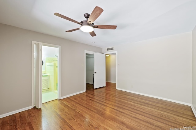 800 Eventide, Terrell Hills, TX 78209 - unfurnished bedroom with visible vents, wood finished floors, baseboards, a closet, and ensuite bath