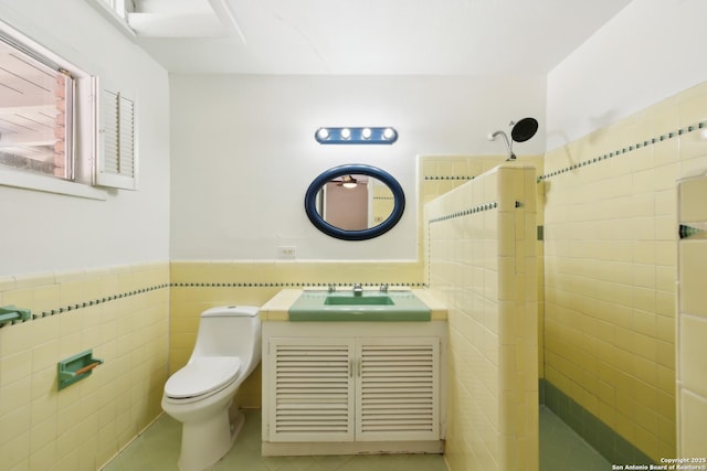 800 Eventide, Terrell Hills, TX 78209 - full bathroom with wainscoting, tile patterned flooring, vanity, toilet, and tile walls