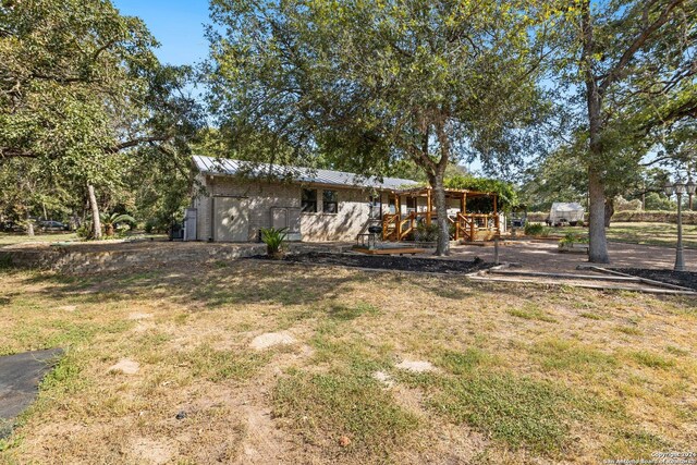 296 Wolf Ln, La Vernia, TX 78121 - exterior space featuring metal roof and a lawn