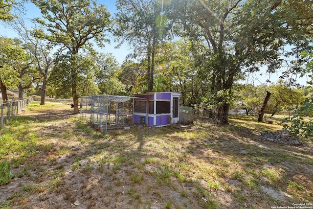 296 Wolf Ln, La Vernia, TX 78121 - view of yard featuring an outdoor structure and fence