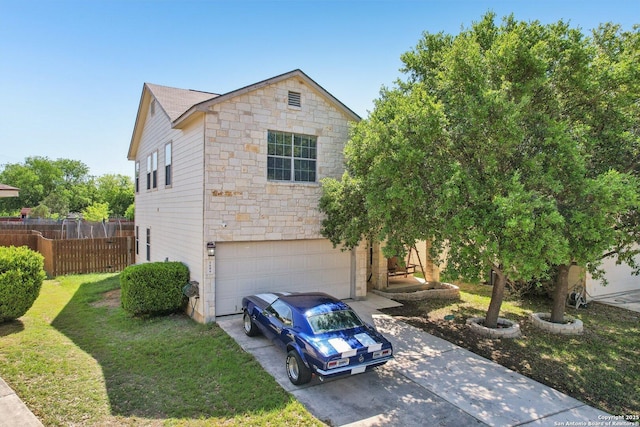 view of front of house featuring driveway, stone siding, an attached garage, a front lawn, and fence