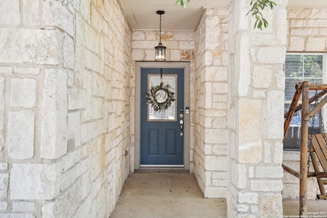 doorway to property with stone siding
