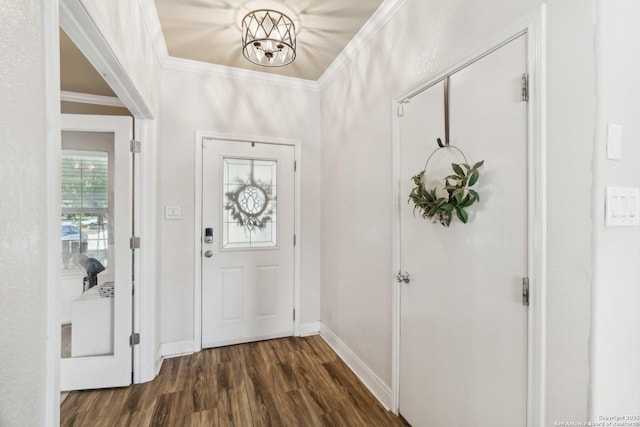 foyer with a notable chandelier, baseboards, ornamental molding, and dark wood finished floors