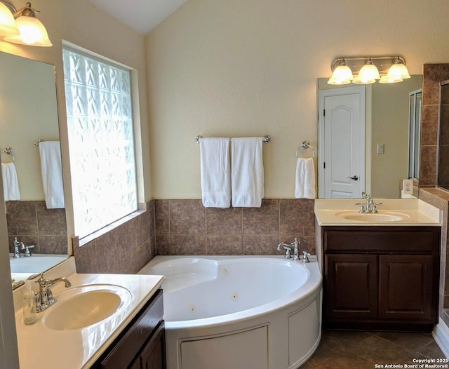 20918 Cactus Rdg, San Antonio, TX 78258 - bathroom with two vanities, a sink, and a tub with jets
