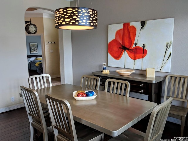 20918 Cactus Rdg, San Antonio, TX 78258 - dining room featuring baseboards, arched walkways, and wood finished floors