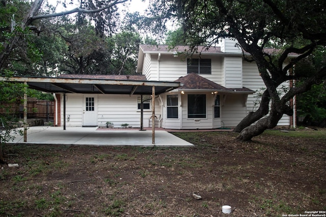 back of property featuring a patio area, roof with shingles, and fence