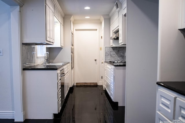 kitchen featuring tasteful backsplash, dark countertops, ventilation hood, and white cabinets