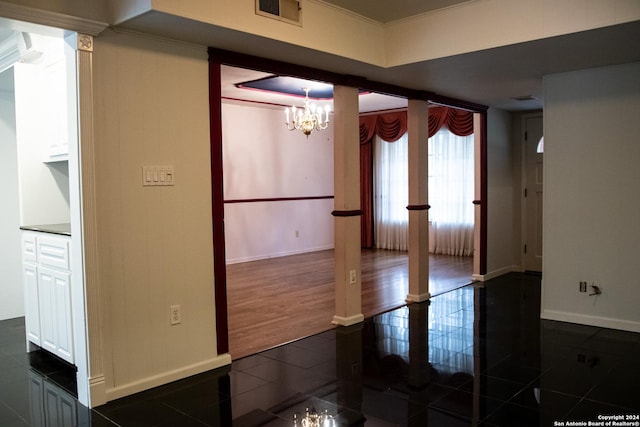 unfurnished room featuring visible vents, baseboards, an inviting chandelier, crown molding, and french doors
