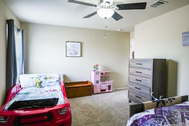 carpeted bedroom with visible vents and a ceiling fan