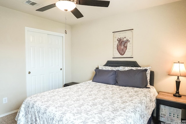 bedroom featuring visible vents, a closet, baseboards, ceiling fan, and carpet floors