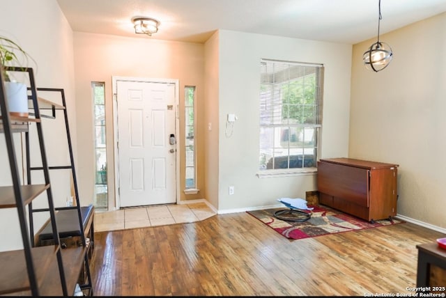 entryway featuring baseboards and wood finished floors