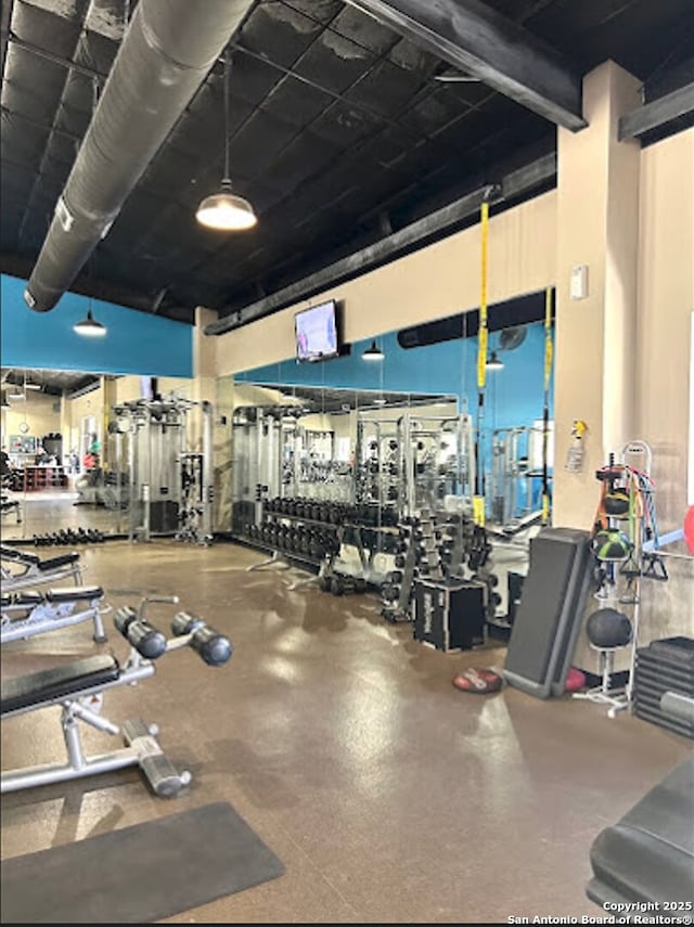 gym featuring a towering ceiling