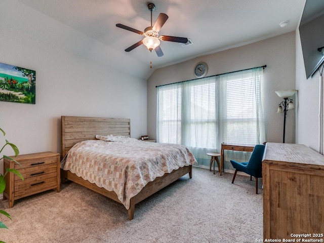 bedroom featuring light carpet, visible vents, a ceiling fan, and lofted ceiling