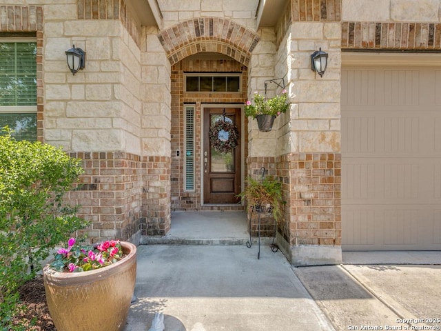 doorway to property featuring brick siding and stone siding