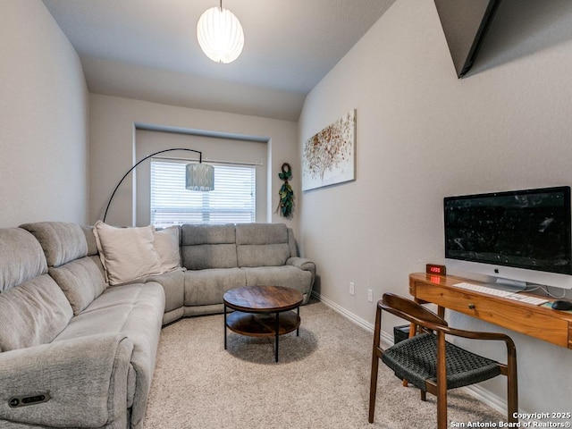 living area featuring baseboards and carpet flooring