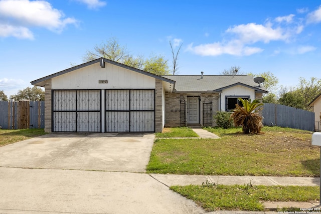 ranch-style home featuring brick siding, an attached garage, fence, and concrete driveway