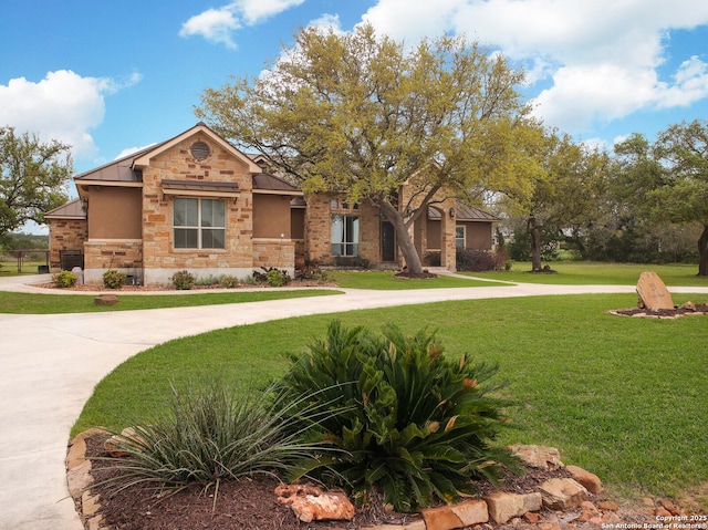 224 E Copper Trce, New Braunfels, TX 78132 - view of front of home with metal roof, a front yard, and stone siding