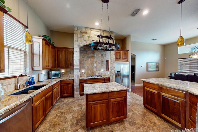 224 E Copper Trce, New Braunfels, TX 78132 - kitchen featuring tasteful backsplash, visible vents, hanging light fixtures, a sink, and appliances with stainless steel finishes