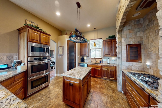 224 E Copper Trce, New Braunfels, TX 78132 - kitchen with visible vents, a sink, light stone countertops, decorative backsplash, and stainless steel appliances
