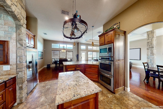 224 E Copper Trce, New Braunfels, TX 78132 - kitchen featuring a peninsula, appliances with stainless steel finishes, ornate columns, and visible vents