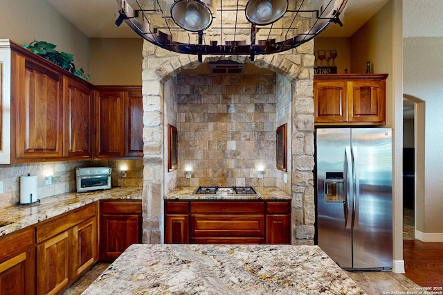 224 E Copper Trce, New Braunfels, TX 78132 - kitchen featuring decorative backsplash, appliances with stainless steel finishes, wood finished floors, and light stone counters