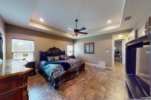 224 E Copper Trce, New Braunfels, TX 78132 - bedroom with a tray ceiling, baseboards, recessed lighting, and visible vents