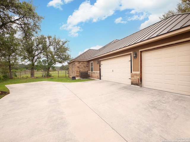 224 E Copper Trce, New Braunfels, TX 78132 - view of side of property with driveway, a garage, a standing seam roof, metal roof, and fence