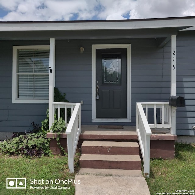 view of exterior entry featuring a porch