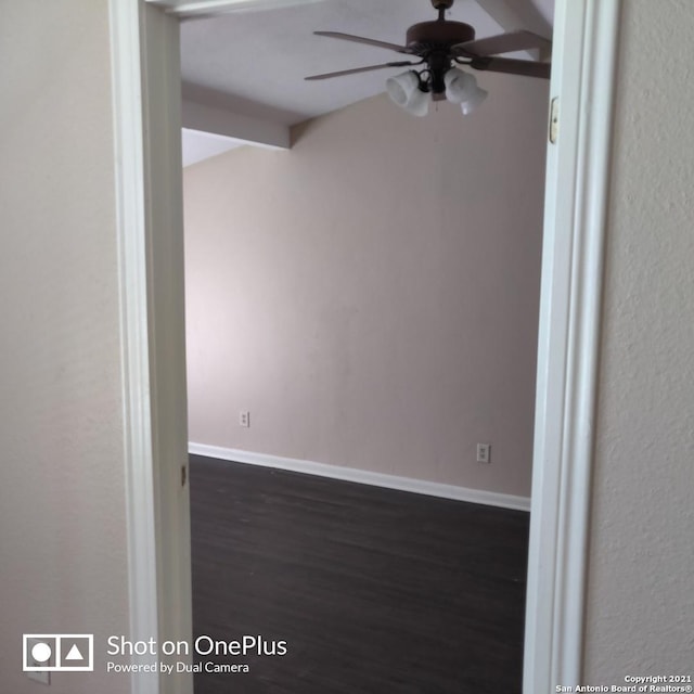 spare room with baseboards, a ceiling fan, and wood finished floors