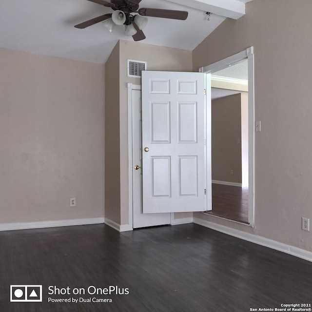 unfurnished bedroom with dark wood finished floors, baseboards, vaulted ceiling with beams, and visible vents