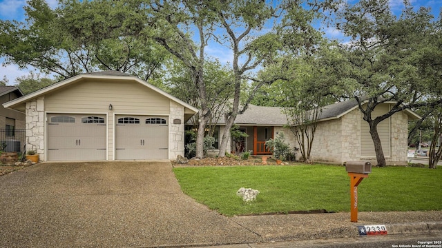 single story home with stone siding, asphalt driveway, a front lawn, and a garage