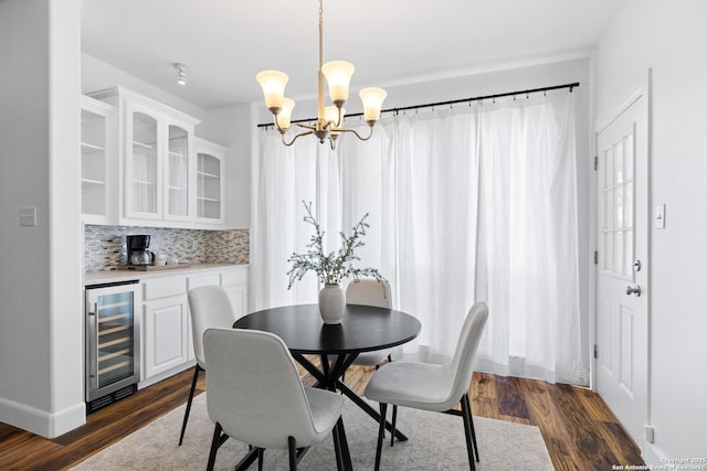 19211 Tierra Cv, San Antonio, TX 78258 - dining room with a chandelier, dark wood-style flooring, baseboards, and beverage cooler