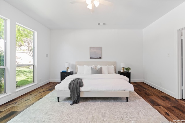 19211 Tierra Cv, San Antonio, TX 78258 - bedroom featuring visible vents, baseboards, a ceiling fan, and dark wood finished floors