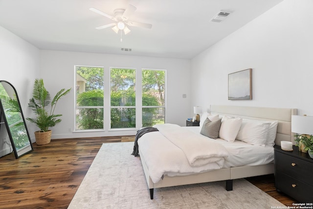 19211 Tierra Cv, San Antonio, TX 78258 - bedroom with dark wood-style flooring, baseboards, visible vents, and ceiling fan