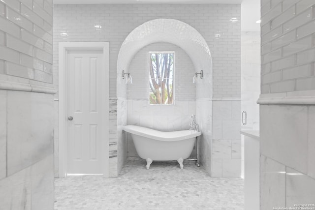 19211 Tierra Cv, San Antonio, TX 78258 - bathroom with a freestanding bath and tile walls