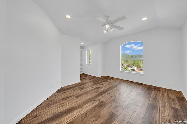 19211 Tierra Cv, San Antonio, TX 78258 - empty room with a ceiling fan, vaulted ceiling, recessed lighting, wood finished floors, and baseboards