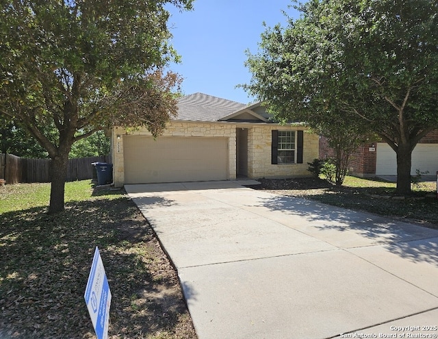 5334 Lowry Peterson, San Antonio, TX 78227 - view of front of home with a garage, a shingled roof, fence, stone siding, and concrete driveway