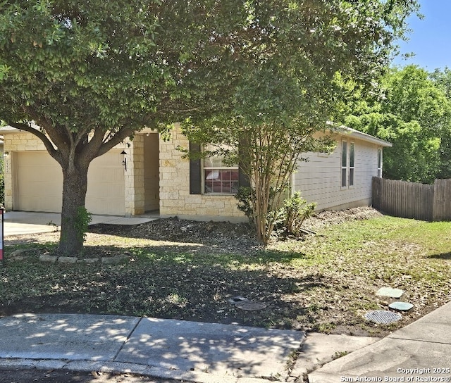 5334 Lowry Peterson, San Antonio, TX 78227 - obstructed view of property with an attached garage, fence, and stone siding