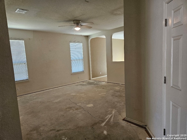 5334 Lowry Peterson, San Antonio, TX 78227 - spare room featuring arched walkways, visible vents, a ceiling fan, and plenty of natural light