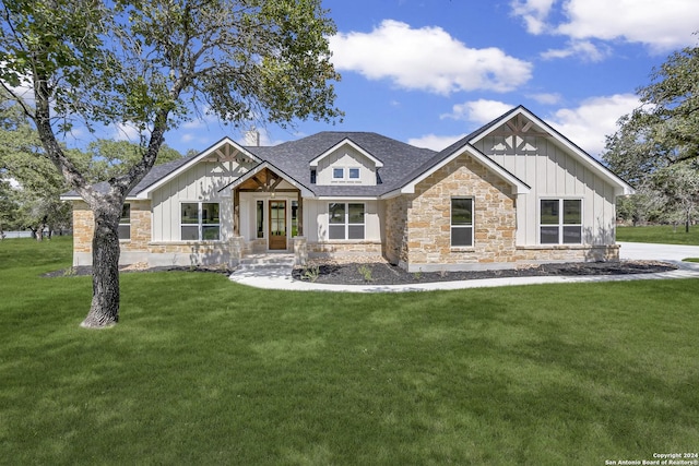 200 Bobby Lynn, Adkins, TX 78101 - view of front of house with a front yard, roof with shingles, board and batten siding, and stone siding