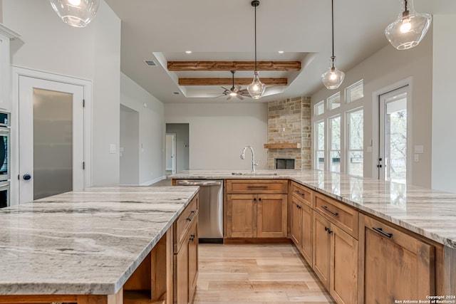 200 Bobby Lynn, Adkins, TX 78101 - kitchen featuring a large island, a ceiling fan, a tray ceiling, appliances with stainless steel finishes, and a sink