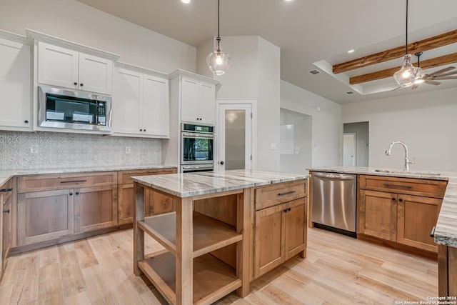 200 Bobby Lynn, Adkins, TX 78101 - kitchen with stainless steel appliances, light wood-style floors, a sink, and a kitchen island