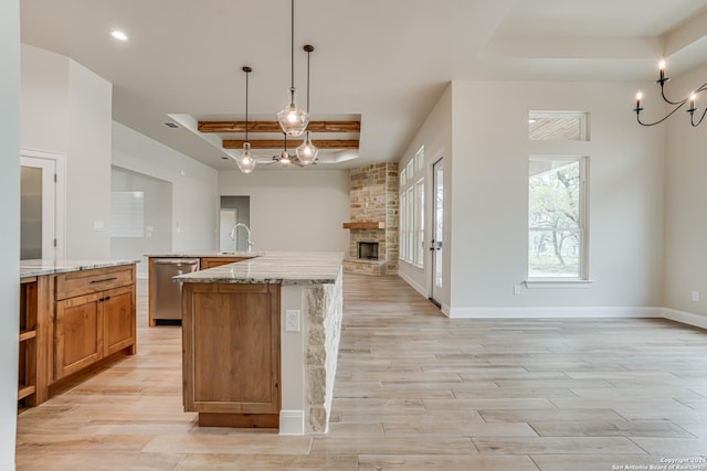 200 Bobby Lynn, Adkins, TX 78101 - kitchen featuring light wood-type flooring, a stone fireplace, open floor plan, a tray ceiling, and dishwasher