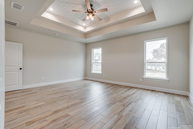 200 Bobby Lynn, Adkins, TX 78101 - unfurnished room featuring a tray ceiling, light wood-type flooring, visible vents, and a ceiling fan