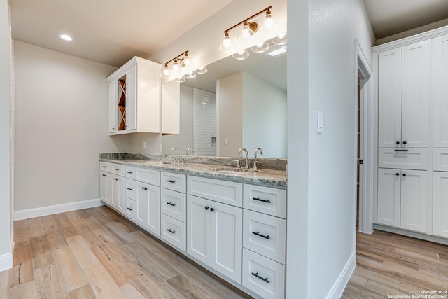 200 Bobby Lynn, Adkins, TX 78101 - full bath featuring a sink, baseboards, double vanity, and wood finished floors