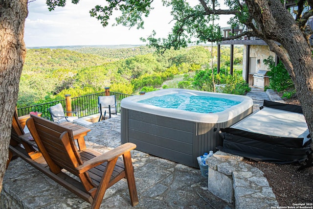 320 Overland Trl W, Hunt, TX 78024 - view of patio / terrace with a forest view and a hot tub