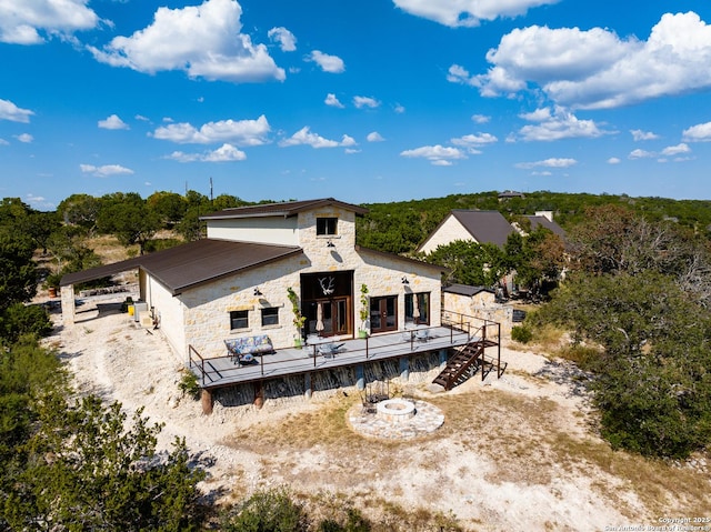 320 Overland Trl W, Hunt, TX 78024 - back of property with an outdoor fire pit and stone siding