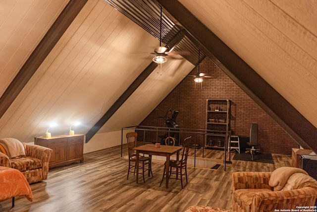 320 Overland Trl W, Hunt, TX 78024 - interior space with brick wall, wood finished floors, lofted ceiling with beams, and a ceiling fan