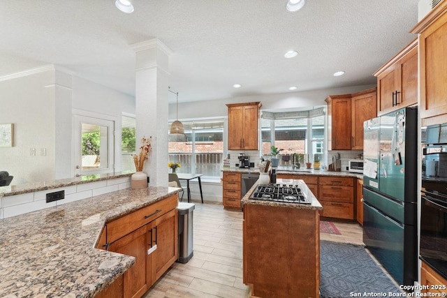 2047 Thicket Trail Dr, San Antonio, TX 78248 - kitchen featuring a healthy amount of sunlight, black appliances, light stone counters, and a kitchen island
